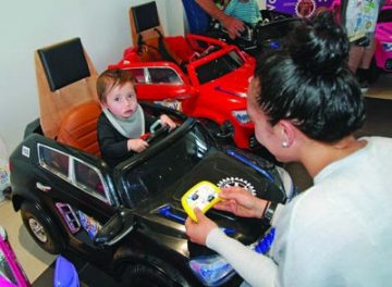 Kingston, 18 months, relaxes in his new BMW as mum learns how to work
the car’s remote.