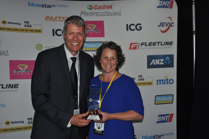 Experieco chief executive Andrew McPherson presents Suzuki NZ marketing manager Fiona Bridgford with the micro/light car Best in Class award for the Suzuki Swift.