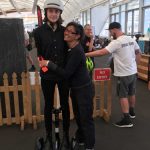 Nikita Hoff-Nielsen from Bikes & Barbers tests a Segway Ninebot with help from mum Darleen.
