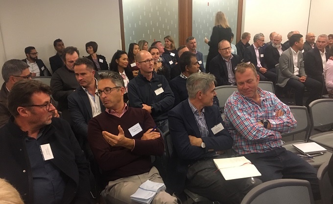 Guests at Drive Electric’s global EV update chat during a break.