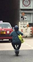 Kiwi-e-scooter-ride-on-Hong-Kong-motorway