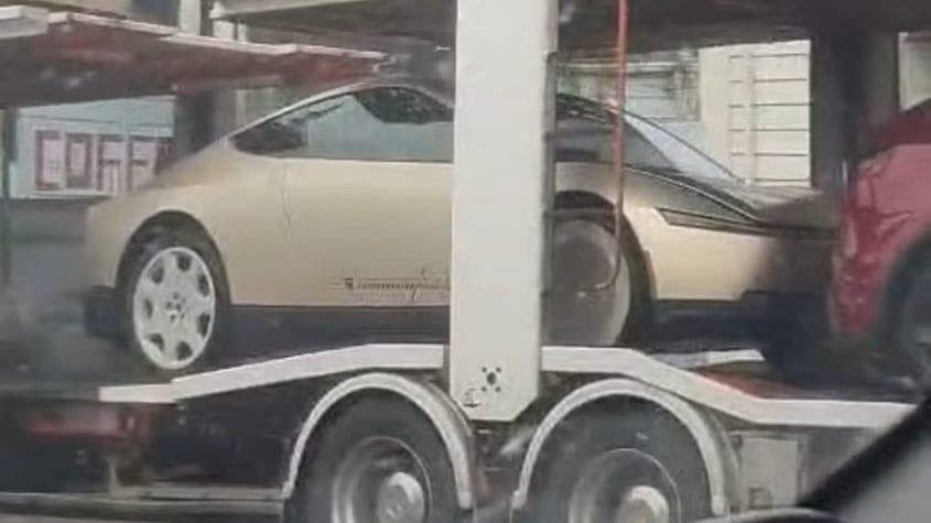 A Cybercab on a transporter in New Zealand during winter testing in June. The gold two-seater has no steering wheel or pedals.