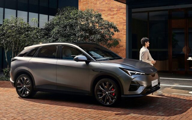Arcfox T5 electric SUV parked outside a brick building