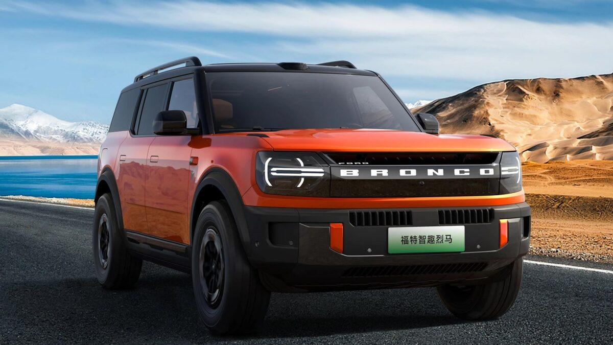 Orange Ford Bronco New Energy front three quarter on a mountain road