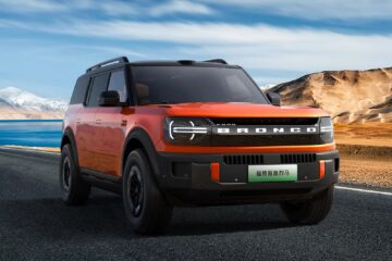 Orange Ford Bronco New Energy front three quarter on a mountain road