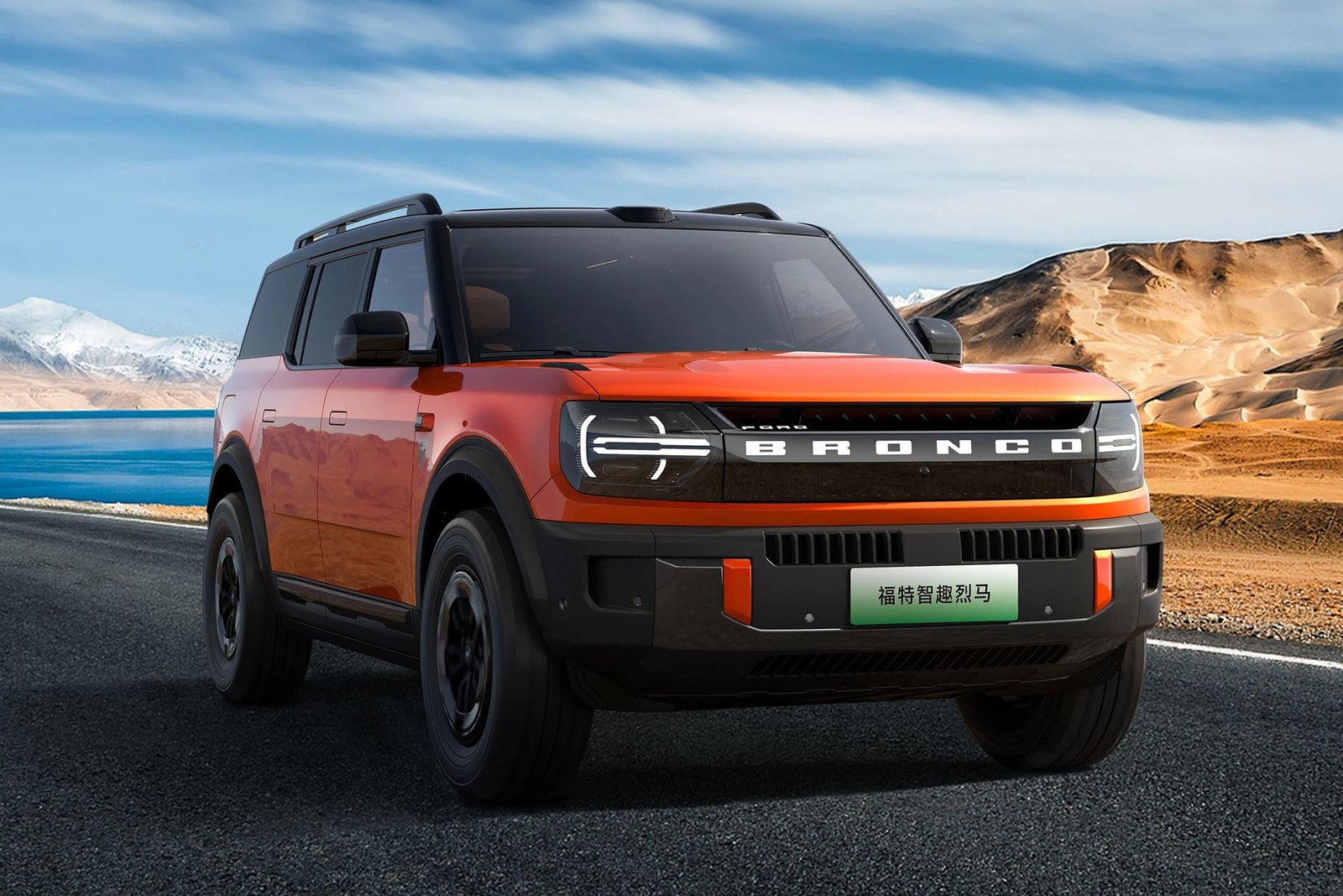 Orange Ford Bronco New Energy front three quarter on a mountain road