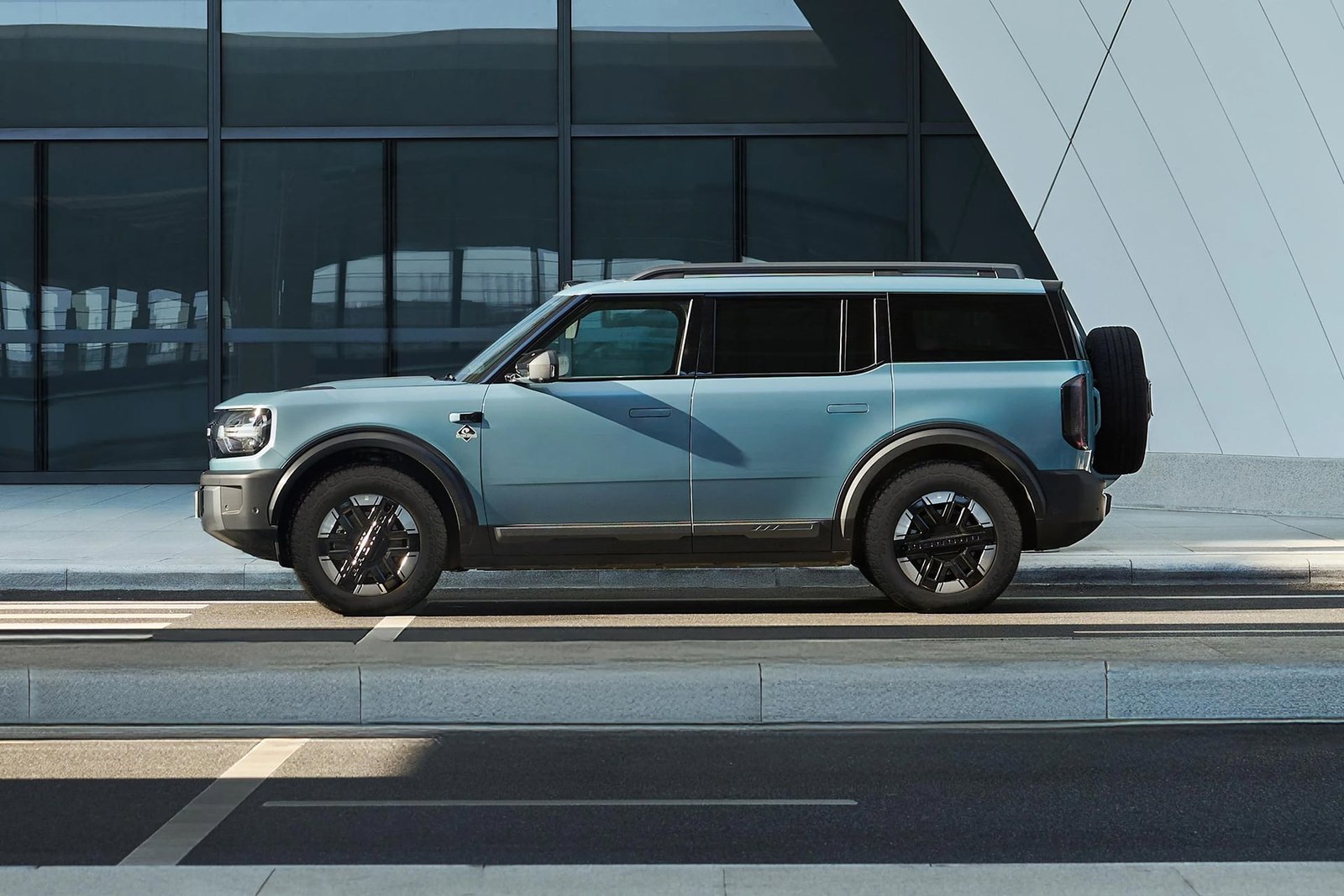 Blue Ford Bronco New Energy side profile with rear-mounted spare