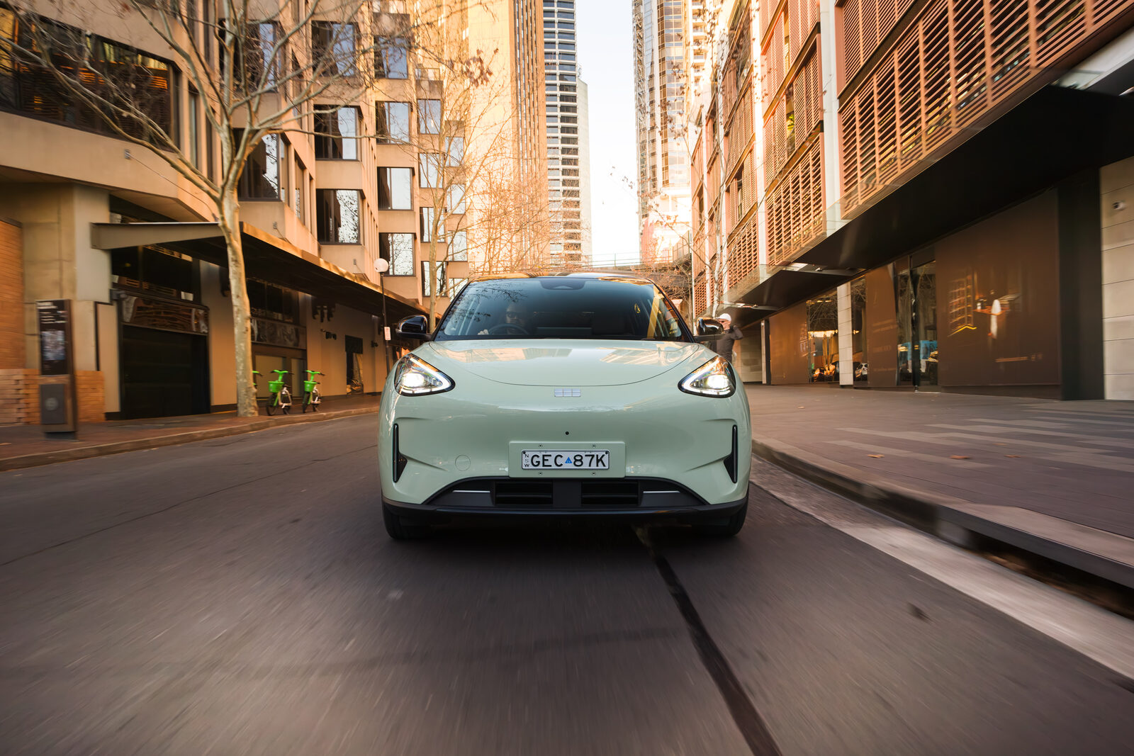 Geely EX2 Inspire driving through city streets