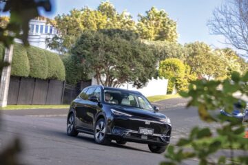 Geely EX5 Inspire cornering on a suburban street