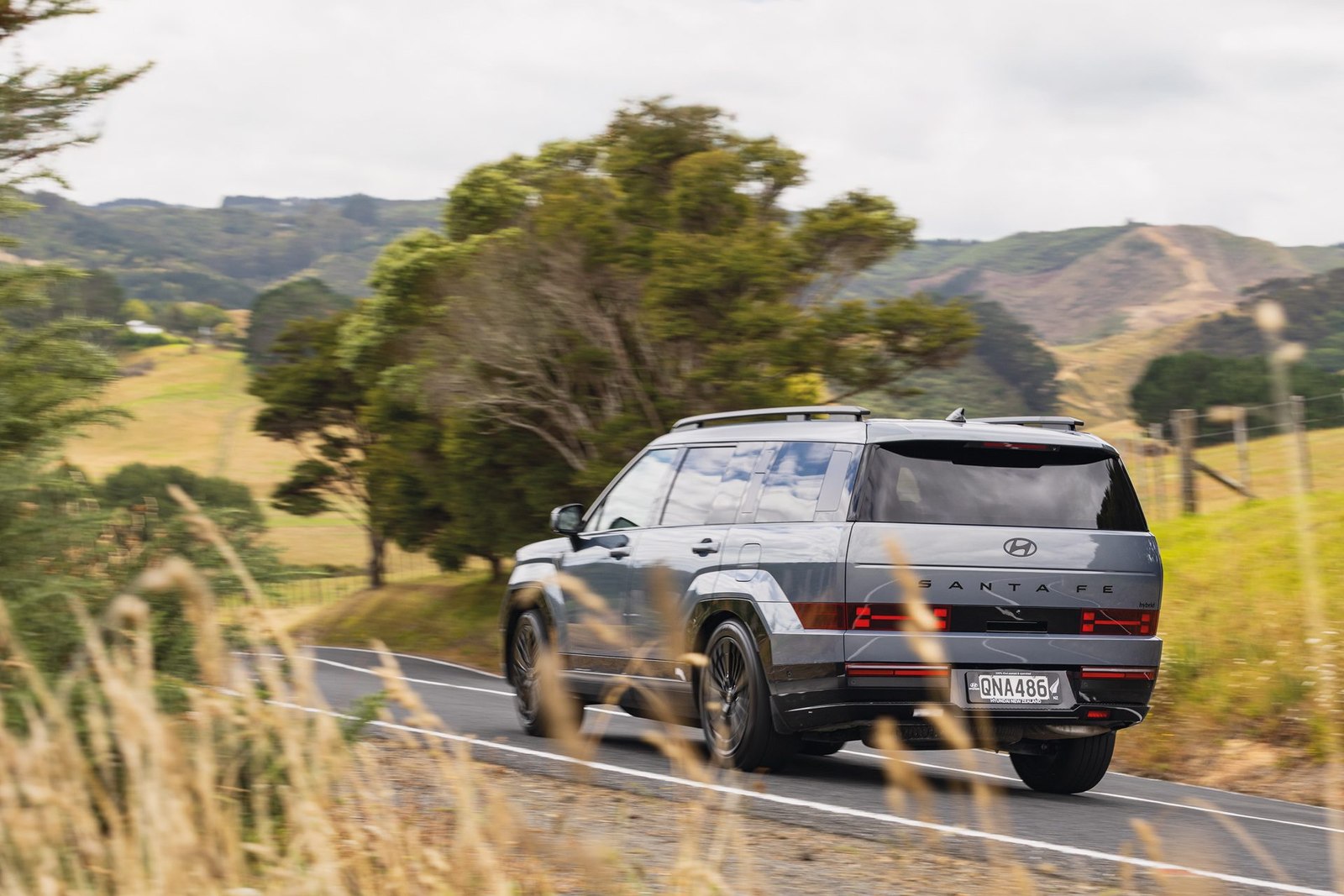 Grey Hyundai Santa Fe rear three quarter on a rural New Zealand road