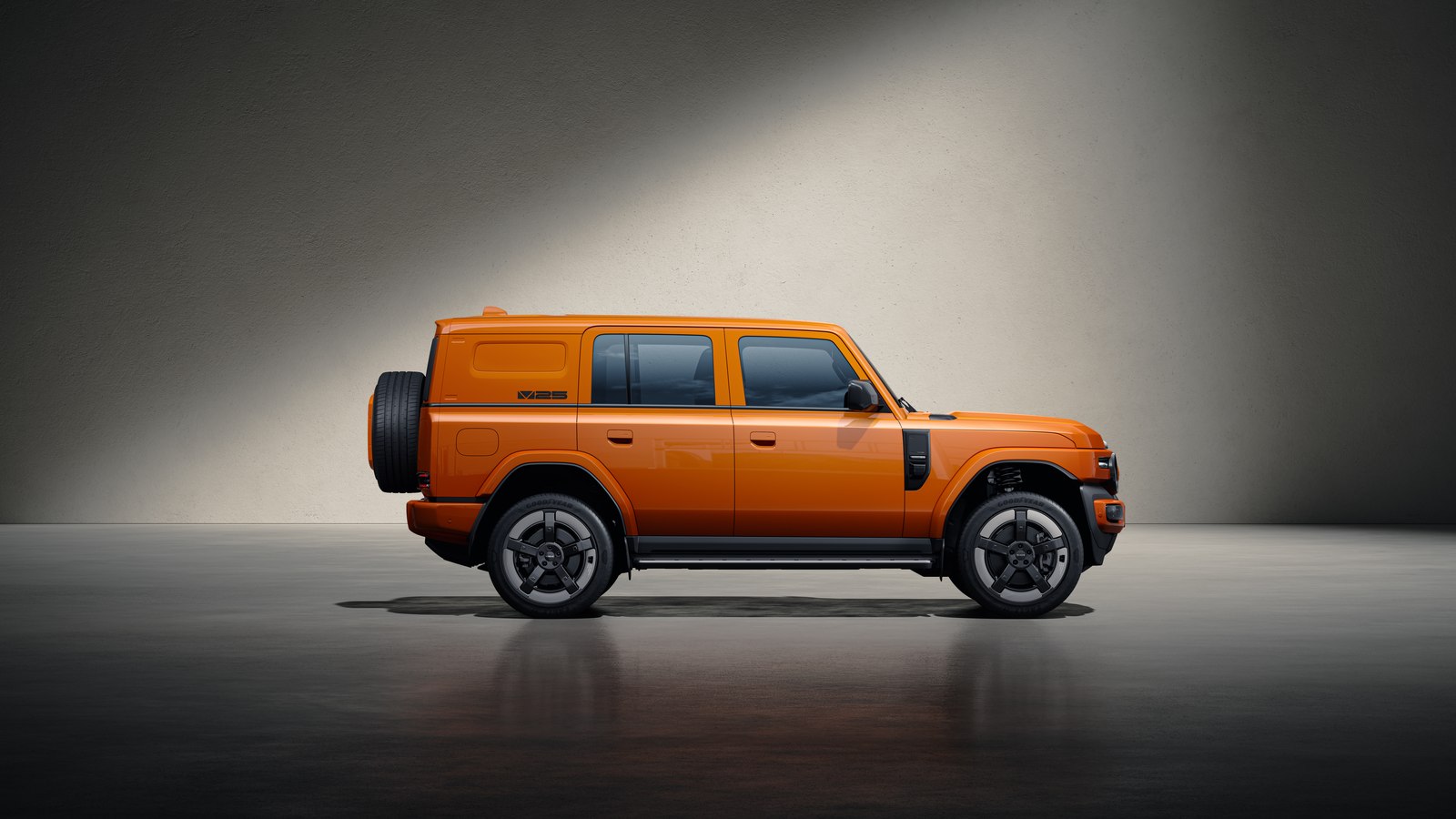 Orange iCaur V25 side profile with rear-mounted spare wheel