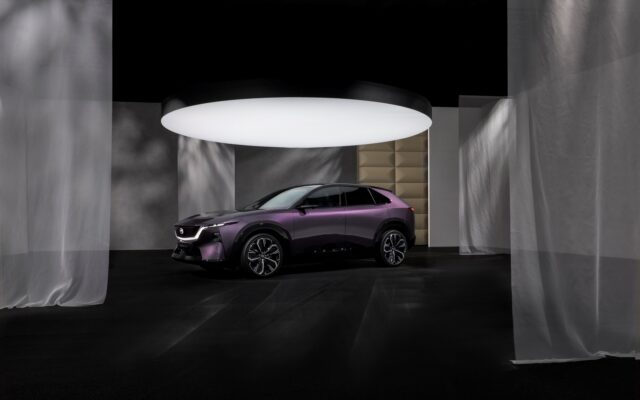 Mazda CX-6e electric SUV in purple, front three quarter