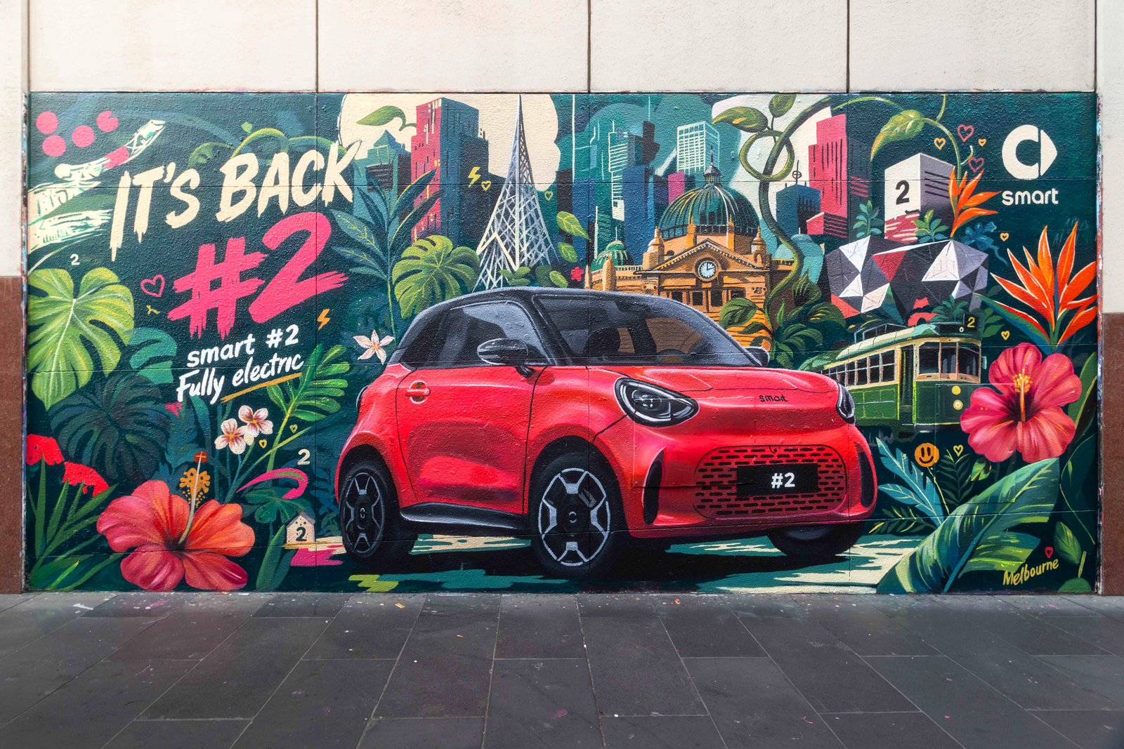 Smart #2 mural by Georgia Laurie in Melbourne showing a red Smart #2 in front of Flinders Street Station