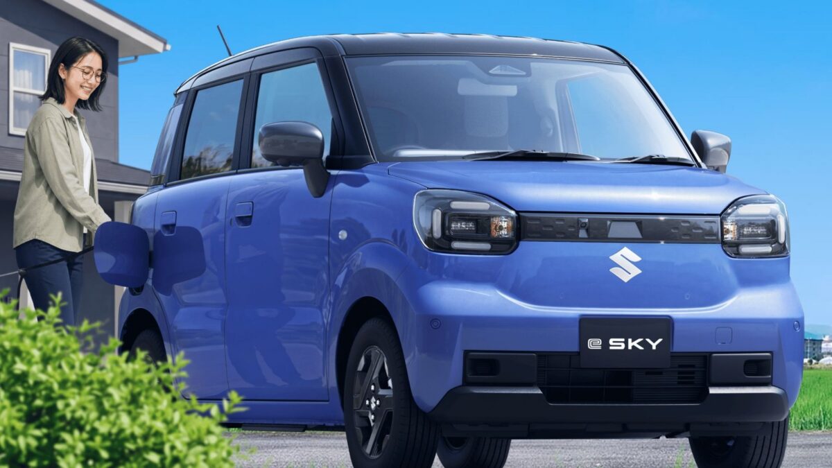 Blue Suzuki e Sky electric kei car parked outside a house