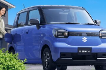 Blue Suzuki e Sky electric kei car parked outside a house