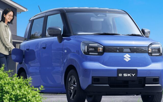 Blue Suzuki e Sky electric kei car parked outside a house
