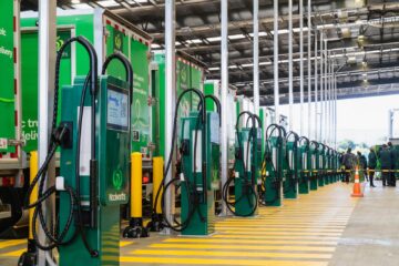 Row of Woolworths EV chargers with electric delivery trucks at the Penrose hub