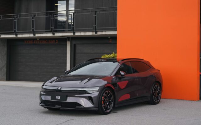 Maroon Zeekr 7GT parked against an orange wall at Highlands