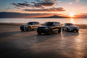 Zeekr 8X, 9X and 7GT parked at a beach at sunset with Rangitoto Island in the background