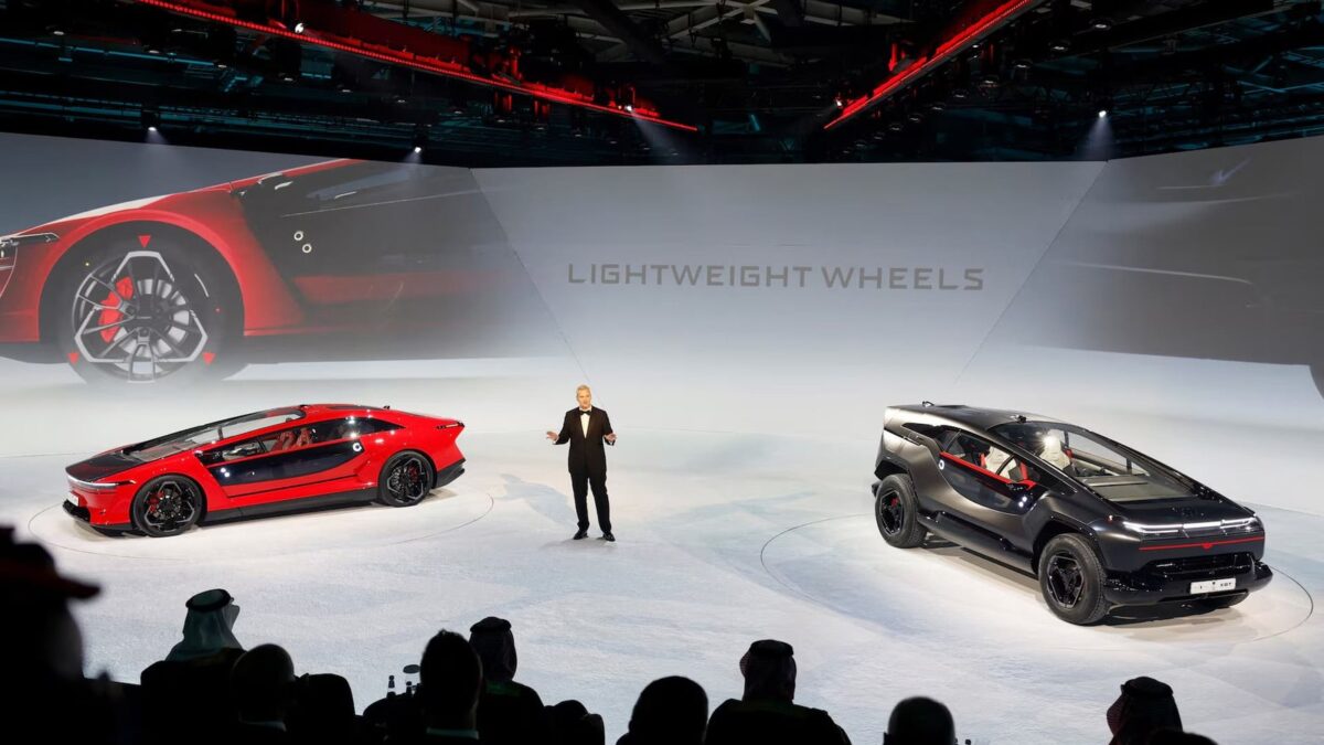 Ceer chief executive Jim DeLuca on stage with the Exobot sedan and SUV