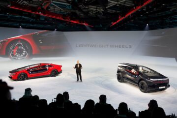 Ceer chief executive Jim DeLuca on stage with the Exobot sedan and SUV