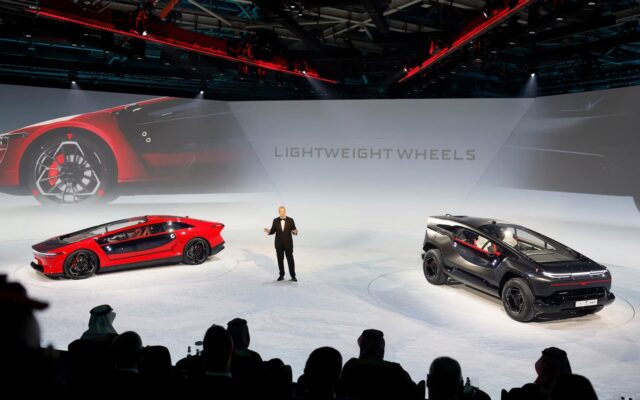 Ceer chief executive Jim DeLuca on stage with the Exobot sedan and SUV