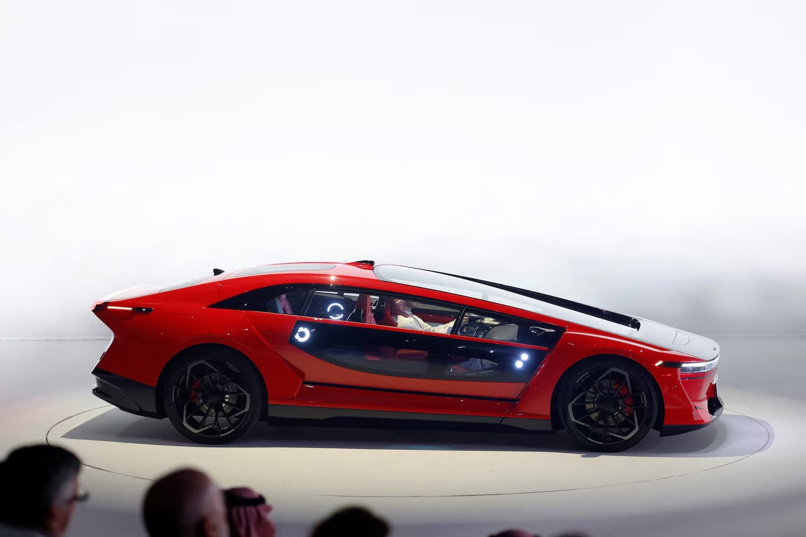 Red Ceer Exobot electric sedan on a launch stage