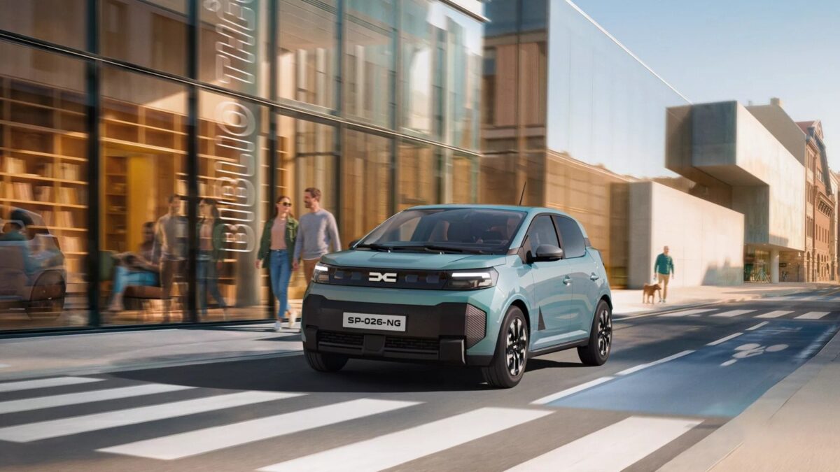 New Dacia Spring in Agave blue on a city street