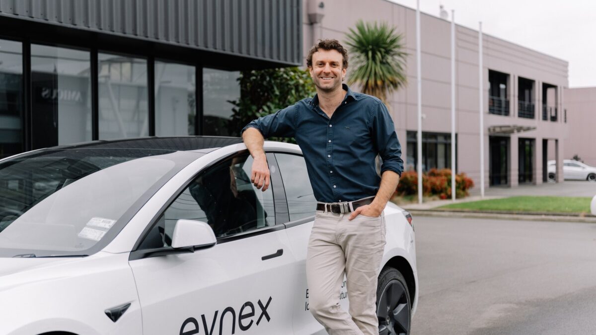 Evnex founder Ed Harvey beside a company car outside its Christchurch premises