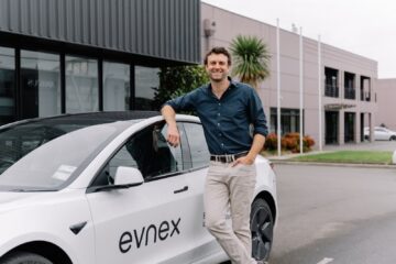 Evnex founder Ed Harvey beside a company car outside its Christchurch premises