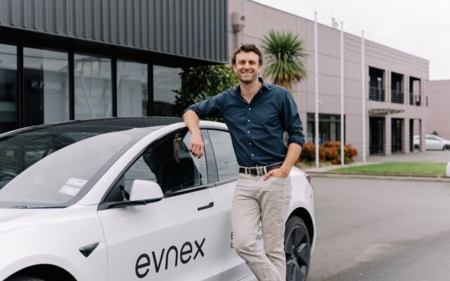 Evnex founder Ed Harvey beside a company car outside its Christchurch premises