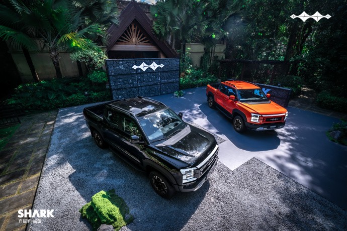 Black and orange Fang Cheng Bao Shark utes parked together