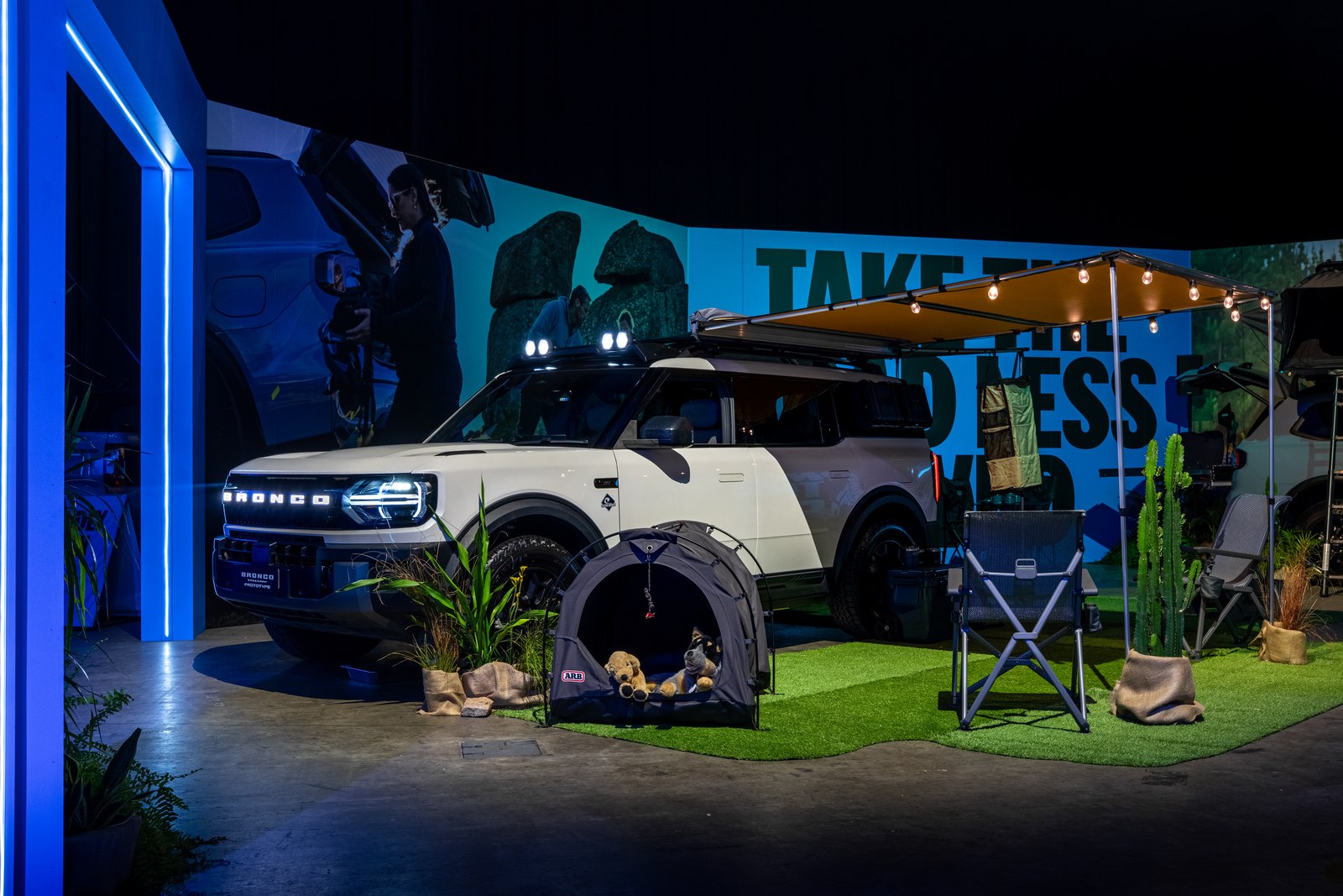 Ford Bronco Basecamp in a camping display with awning and chairs