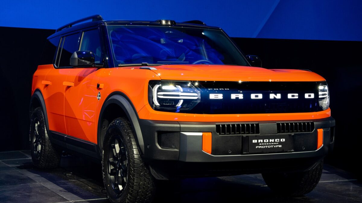 Orange Ford Bronco Basecamp front three quarter on stage