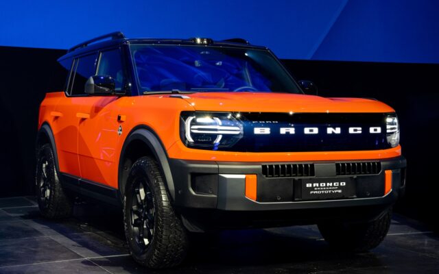 Orange Ford Bronco Basecamp front three quarter on stage