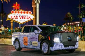 Camouflaged Ford Fathom electric ute in front of the Welcome to Las Vegas sign