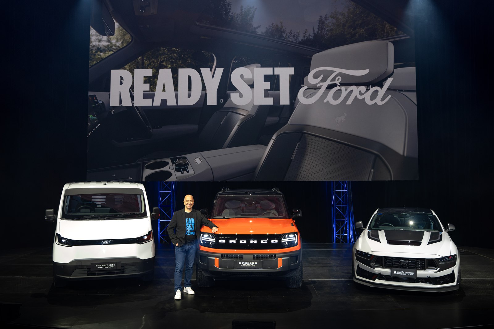 Fadi Mawal on stage with the Transit City, Bronco Basecamp and a third vehicle at Ford Uncovered