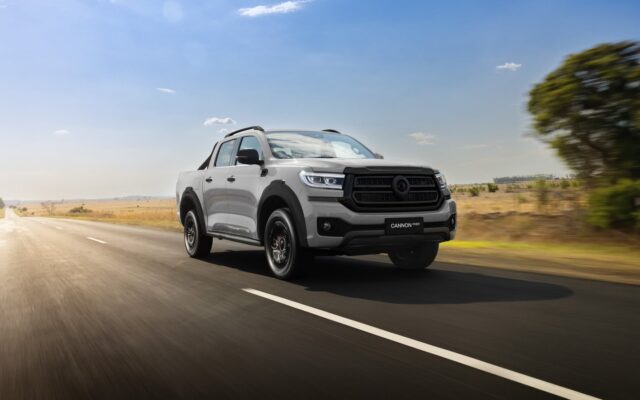 Grey GWM Cannon Hi4-T PHEV ute driving on a country road