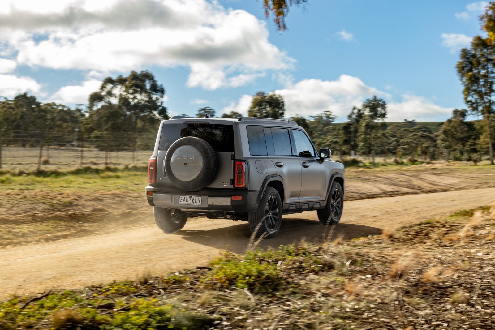Rear view of the GWM Haval H7 on gravel showing the tailgate-mounted spare wheel