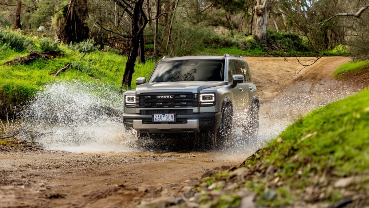 Grey GWM Haval H7 splashing through water on a bush track