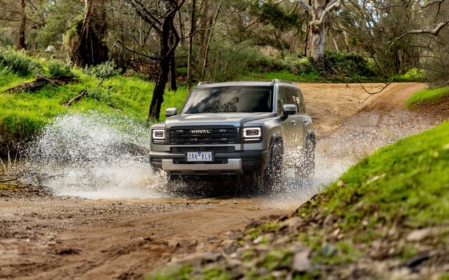 Grey GWM Haval H7 splashing through water on a bush track