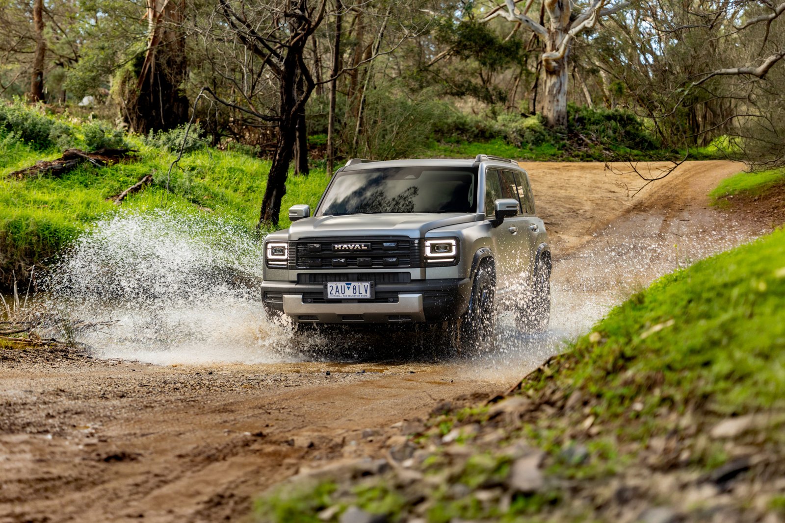 Grey GWM Haval H7 splashing through water on a bush track