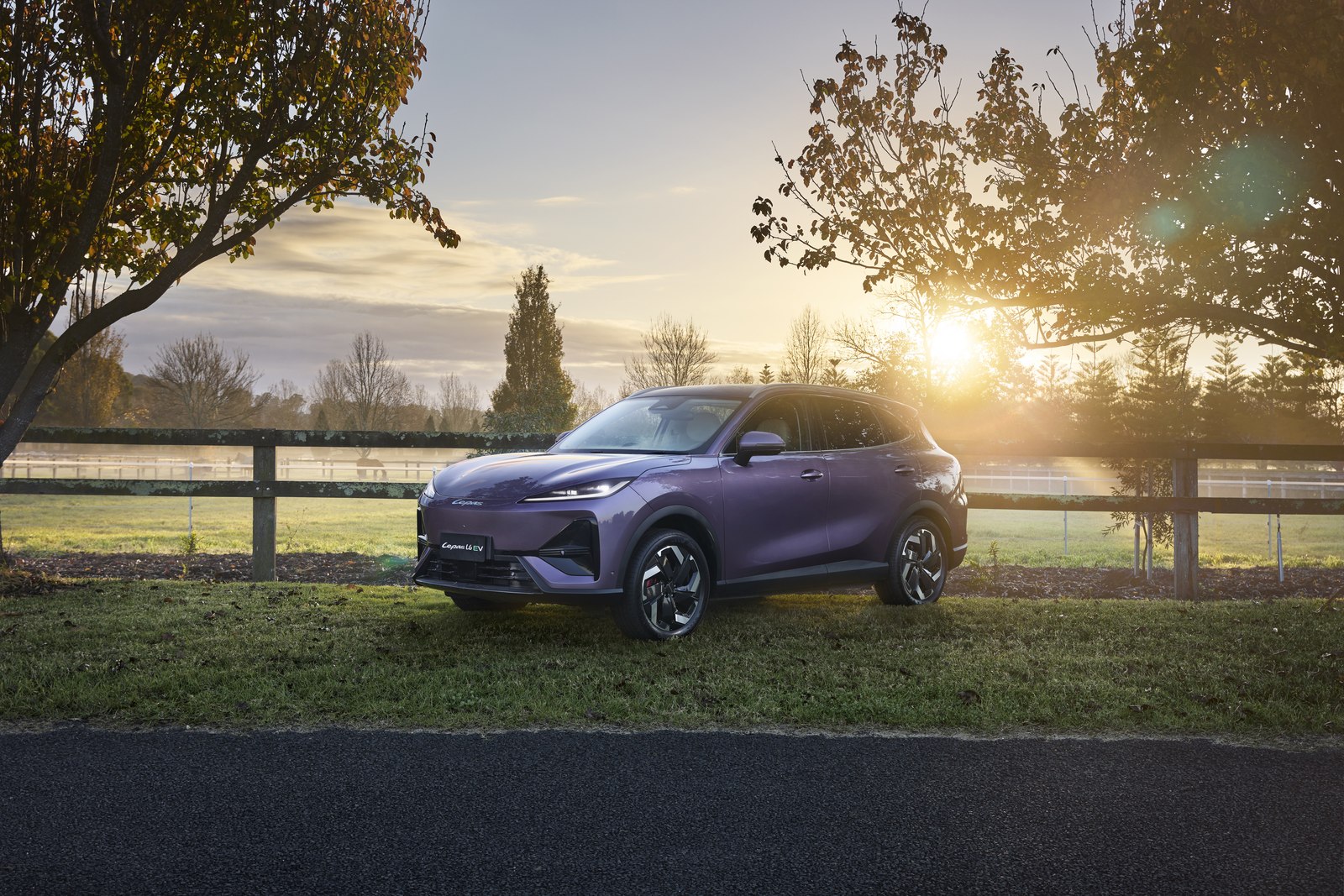 Lepas L6 parked at sunset beside a paddock fence