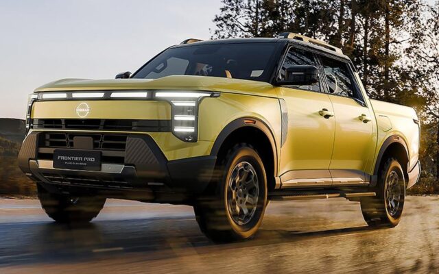 Yellow Nissan Frontier Pro PHEV front three quarter driving on a wet road