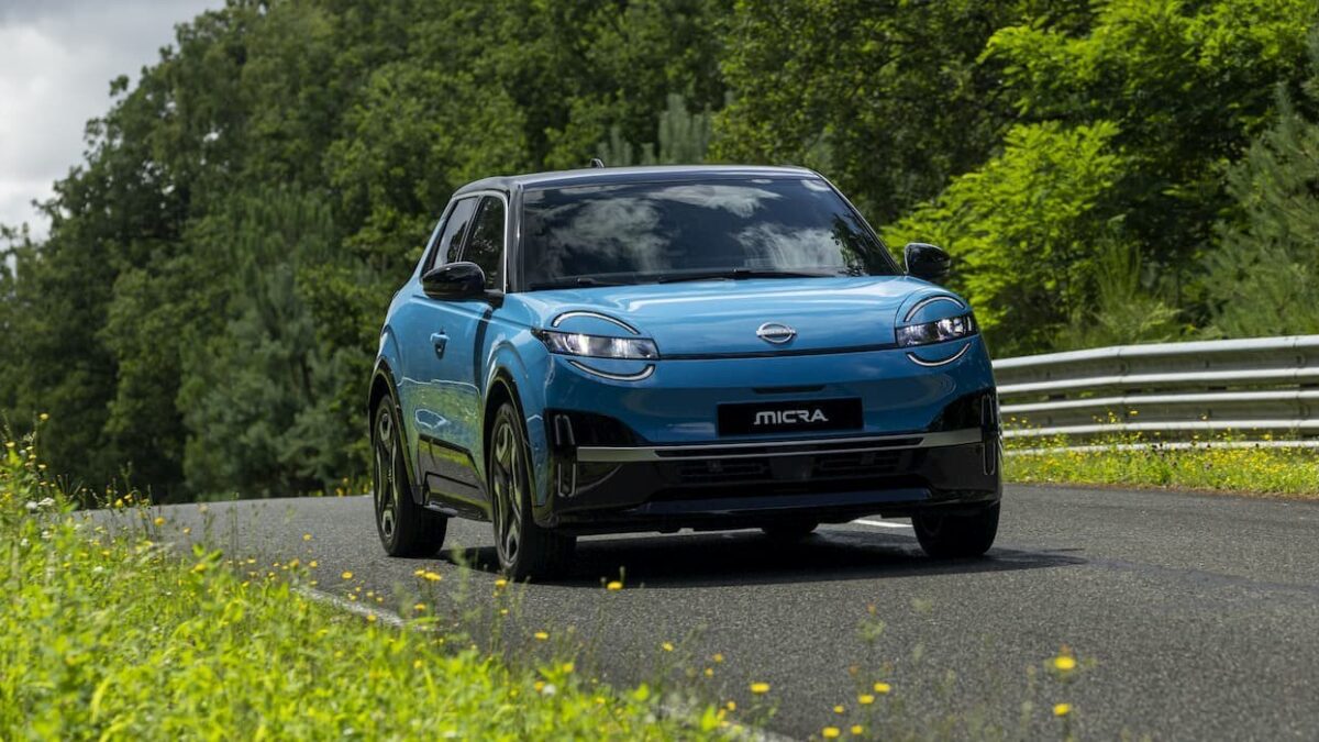 Blue Nissan Micra EV driving on a country road