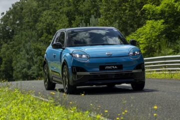 Blue Nissan Micra EV driving on a country road