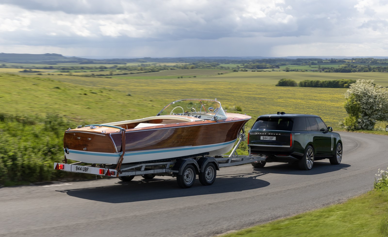 Range Rover Electric towing a wooden boat