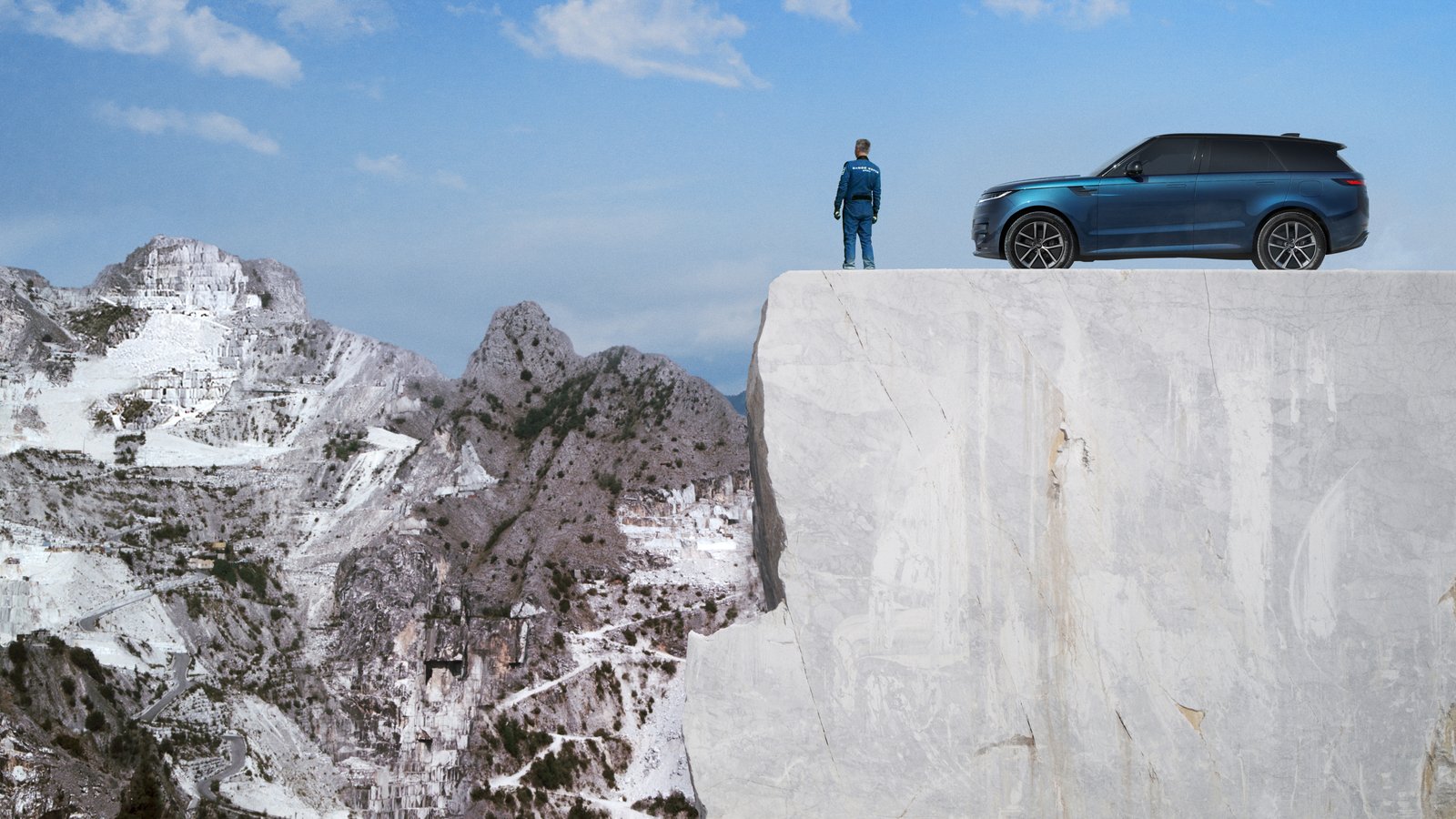 Blue Range Rover Sport Electric parked on a ledge high in a marble quarry