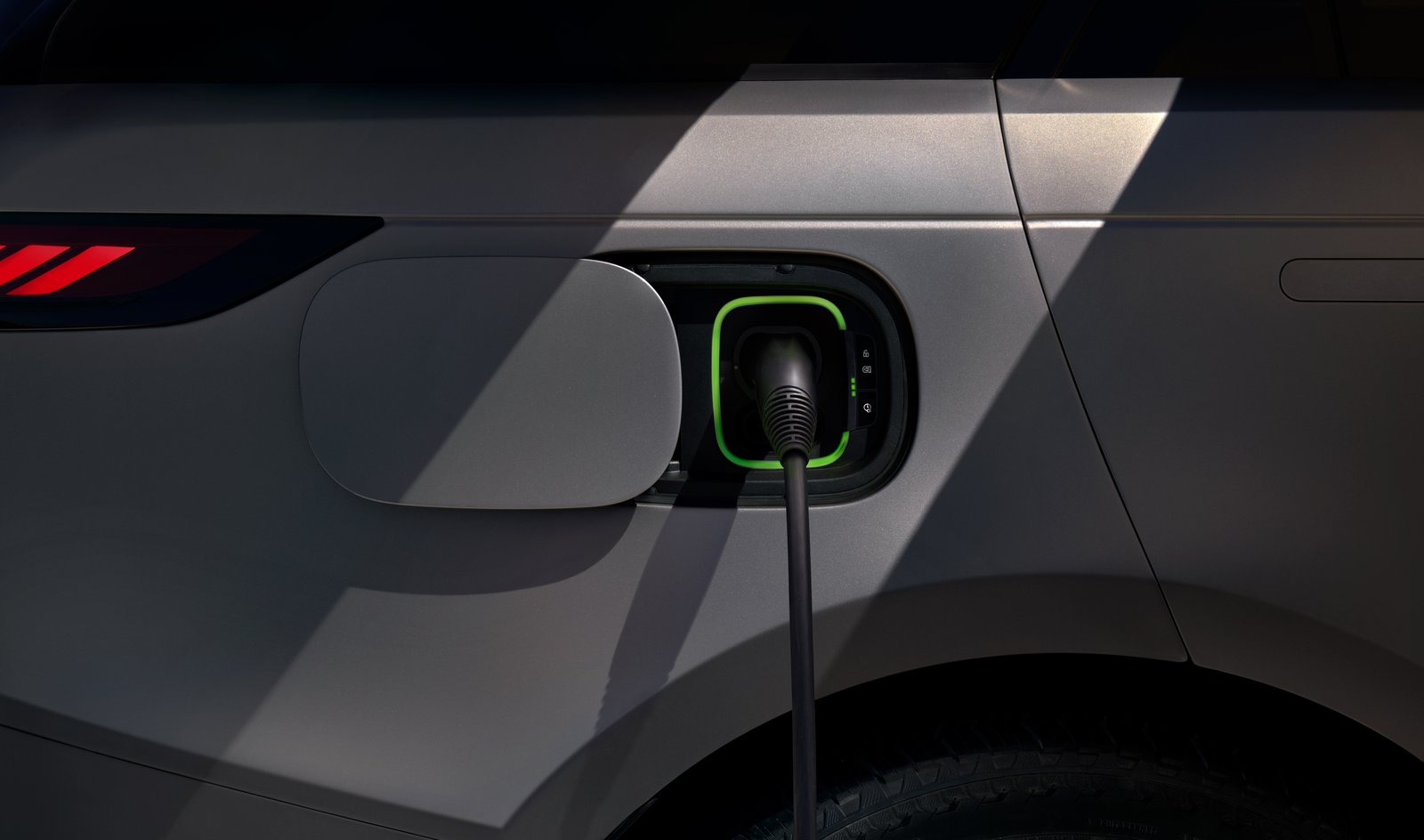 DC charging connector plugged into the Range Rover Sport Electric's charge port