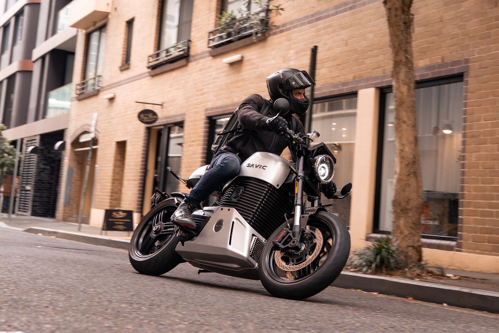 Savic C-Series electric motorcycle being ridden on a city street